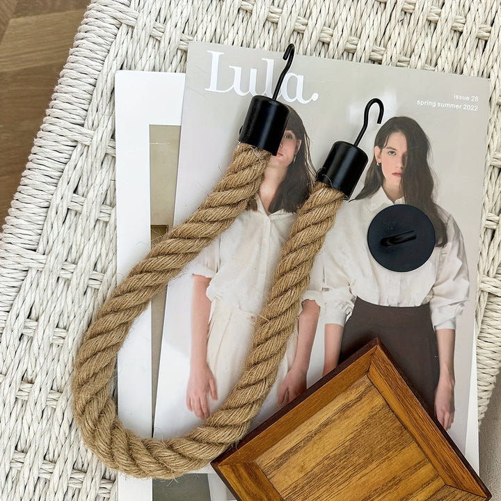 Wall mounted toilet paper holder featuring stylish hemp rope. Perfect rustic bathroom decor.