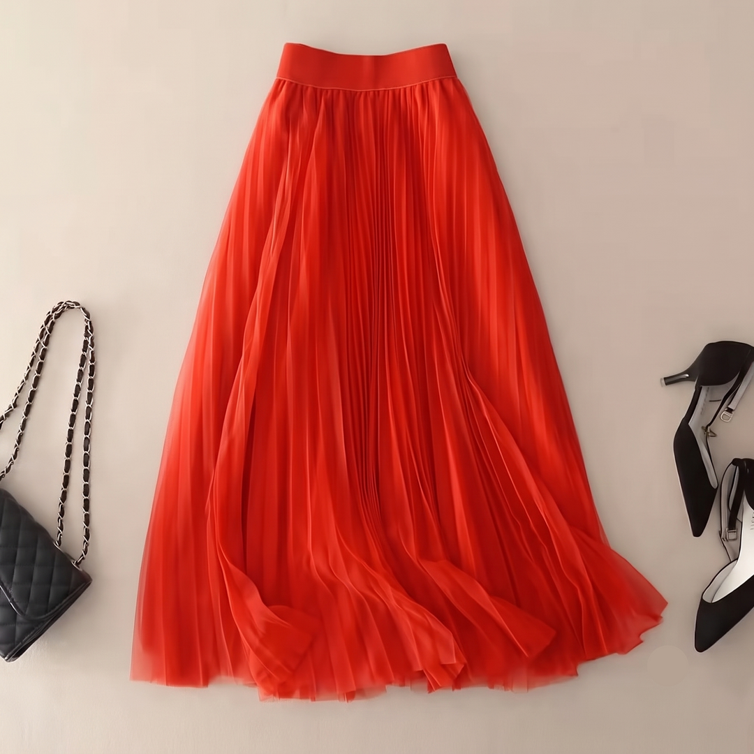 Flowing pleated A-line midi skirt with high waist, ideal for evening wear or versatile event fashion.