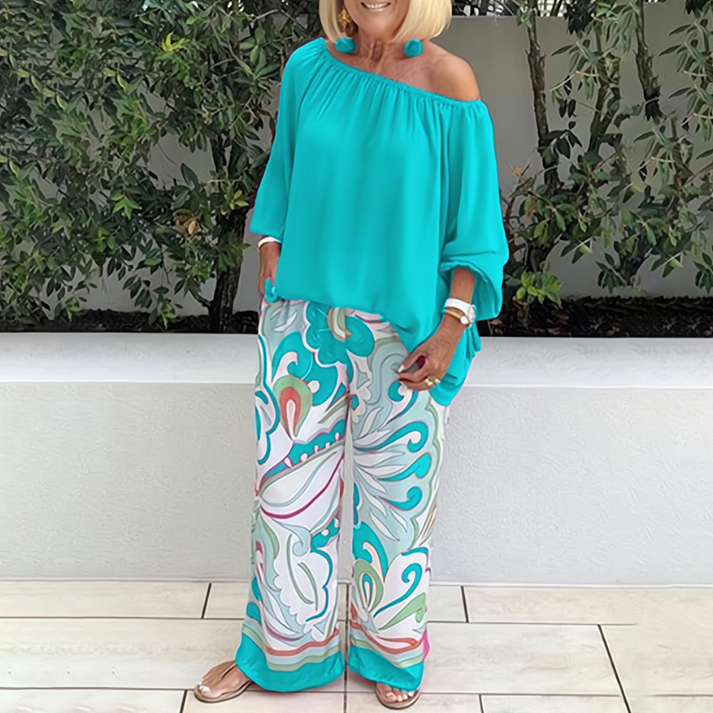 Graceful women's two-piece set featuring wide-leg pants & matching top. Coordinated elegant outfit for summer.