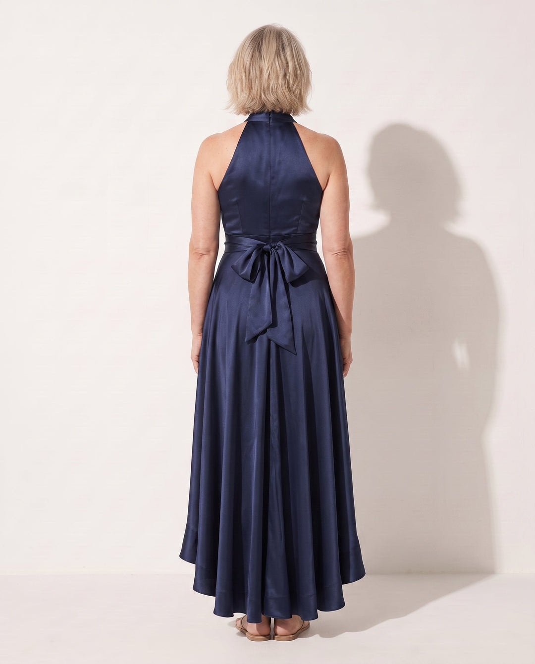 Sophisticated women's halter neck evening gown. This formal maxi dress boasts a flattering design and ruffle hem.