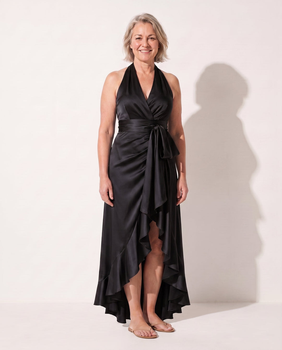 Stylish women's long party dress, halter neck style, with a beautiful ruffle hem. Ideal for formal events.