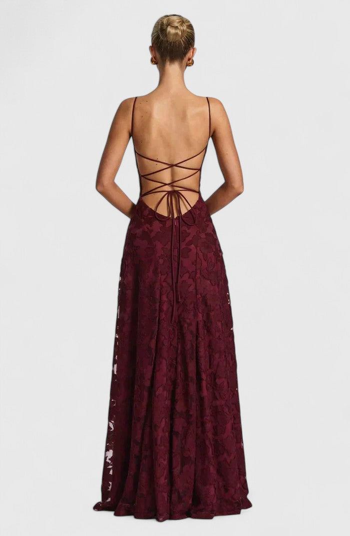 Fashionable women's flowy maxi dress with an elegant open back, perfect for chic parties.