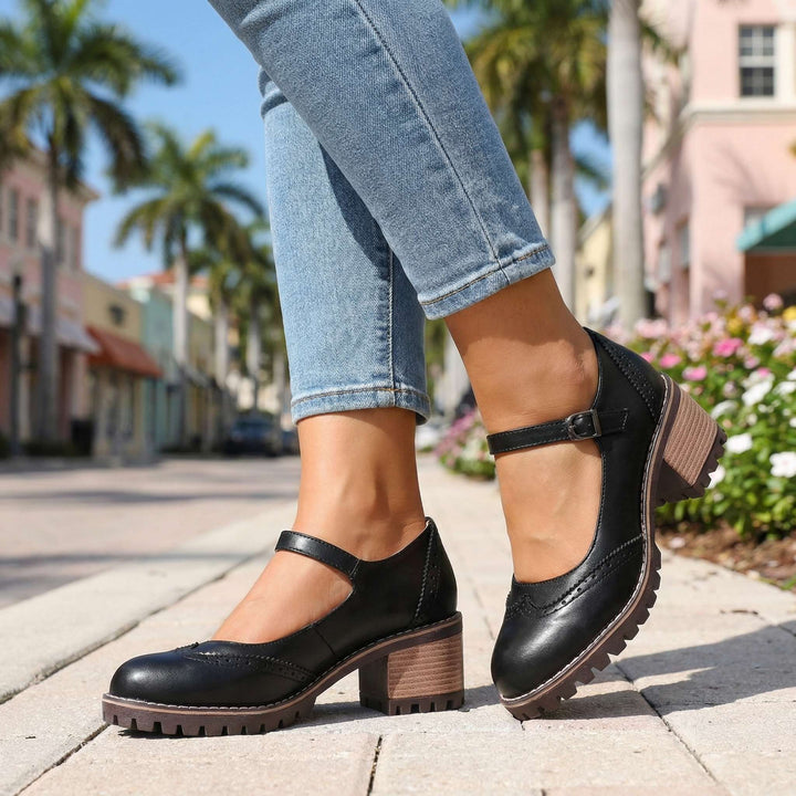 Side view of classic T-strap closed-toe block heels. Women's comfortable and stylish work/event footwear.