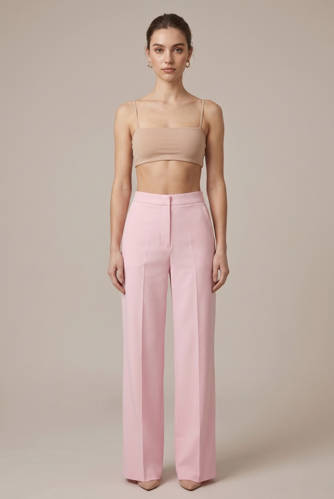 Tailored women's pink blazer with chic feather cuffs. Part of a stylish pant suit, ideal for elegant wear.