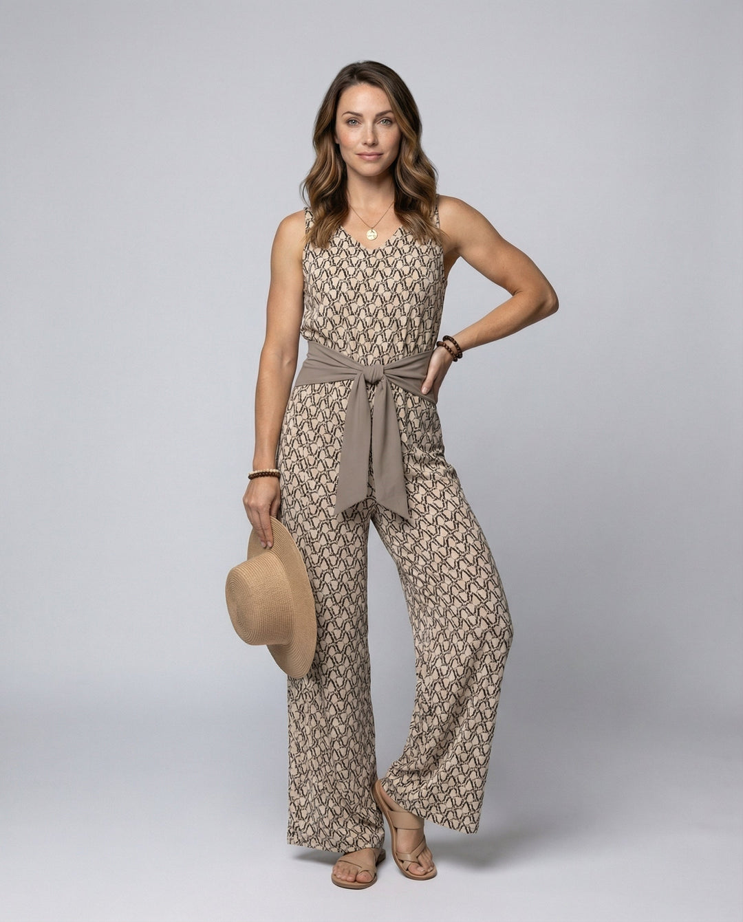 Elegant brown sleeveless women's jumpsuit with a round neck, perfect for versatile summer fashion and casual comfort.
