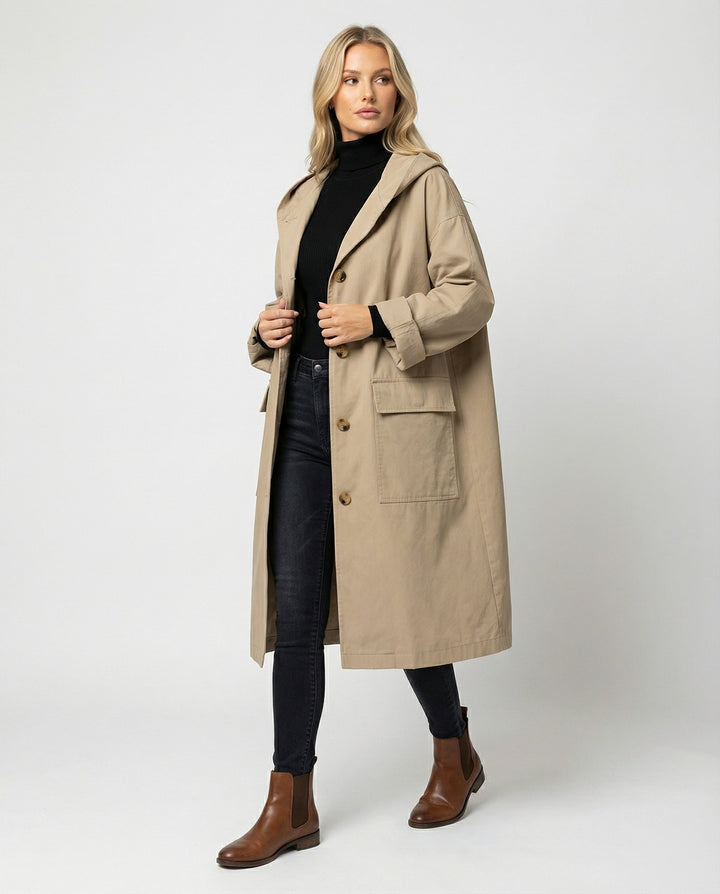Elegant women's long waterproof trench coat in classic beige, perfect for stylish all-weather outerwear.