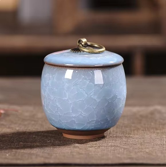 White craquelé glaze ceramic urn for pet ashes, a serene and elegant home memorial keepsake.