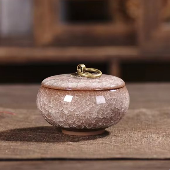 Ceramic urn with craquelé glaze detail, a touching memorial for beloved cat or dog's ashes.