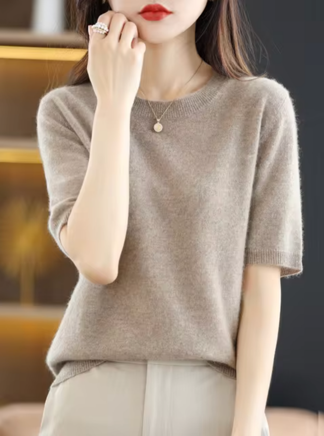 Chic women's short-sleeve knit top. Elegant, cozy, and versatile for modern everyday style.