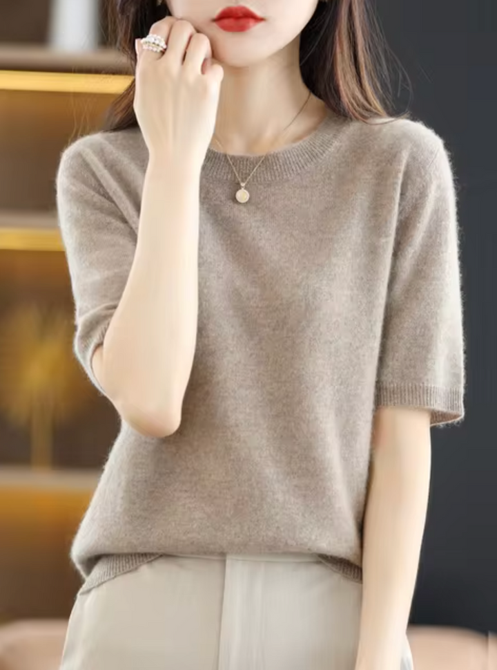 Chic women's short-sleeve knit top. Elegant, cozy, and versatile for modern everyday style.