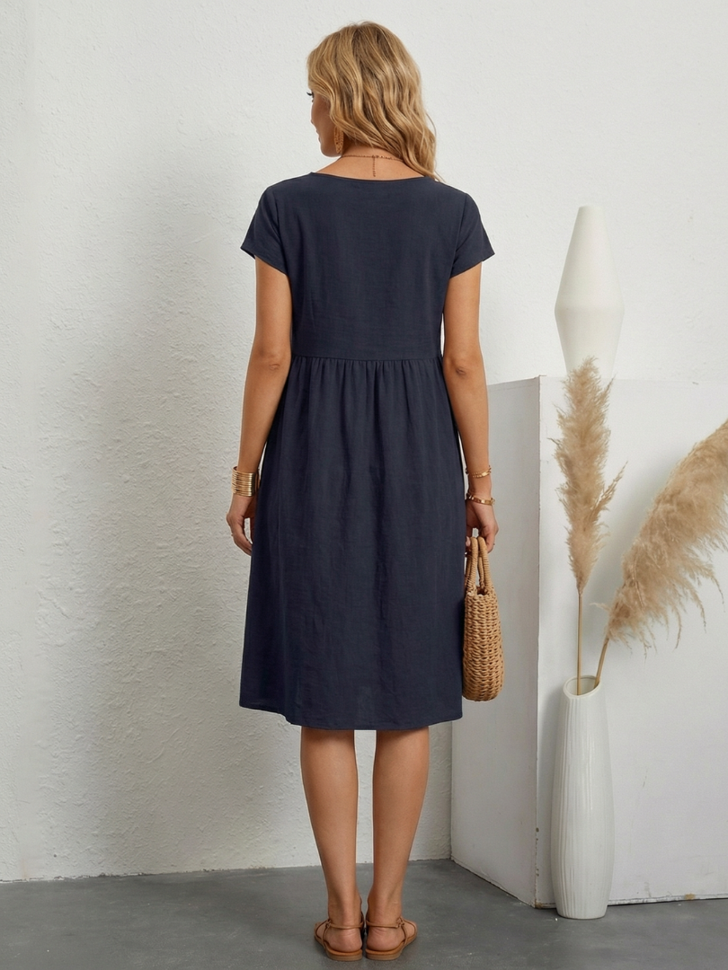 Casual women's short sleeve knee length pocket dress. Features a relaxed fit for daily comfort.