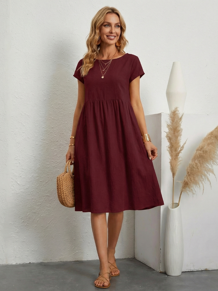 Everyday women's short sleeve knee length pocket dress. Practical design, comfortable for daily wear.