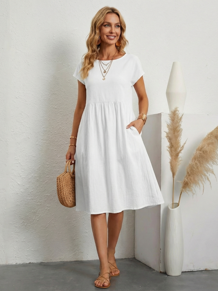 Chic women's short sleeve knee length dress. Stylish and comfortable with pockets for everyday elegance.