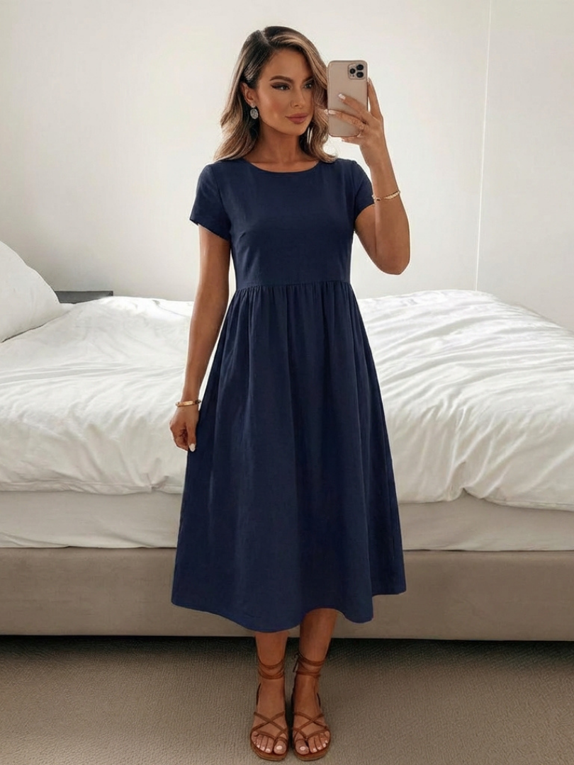Comfortable women's short sleeve knee length dress with pockets. Perfect for relaxed everyday wear.