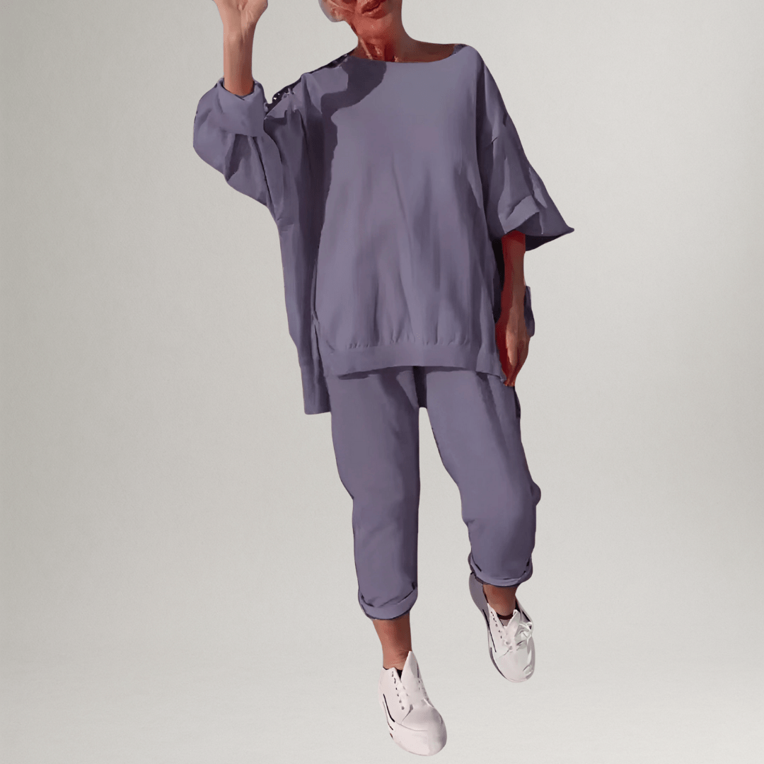 Neatly folded women's matching two-piece set: oversized blouse & wide-leg trousers, perfect for casual elegance.