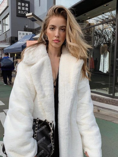 Glamorous women's long winter jacket. Chic outerwear for elegant style, perfect for cold weather fashion.
