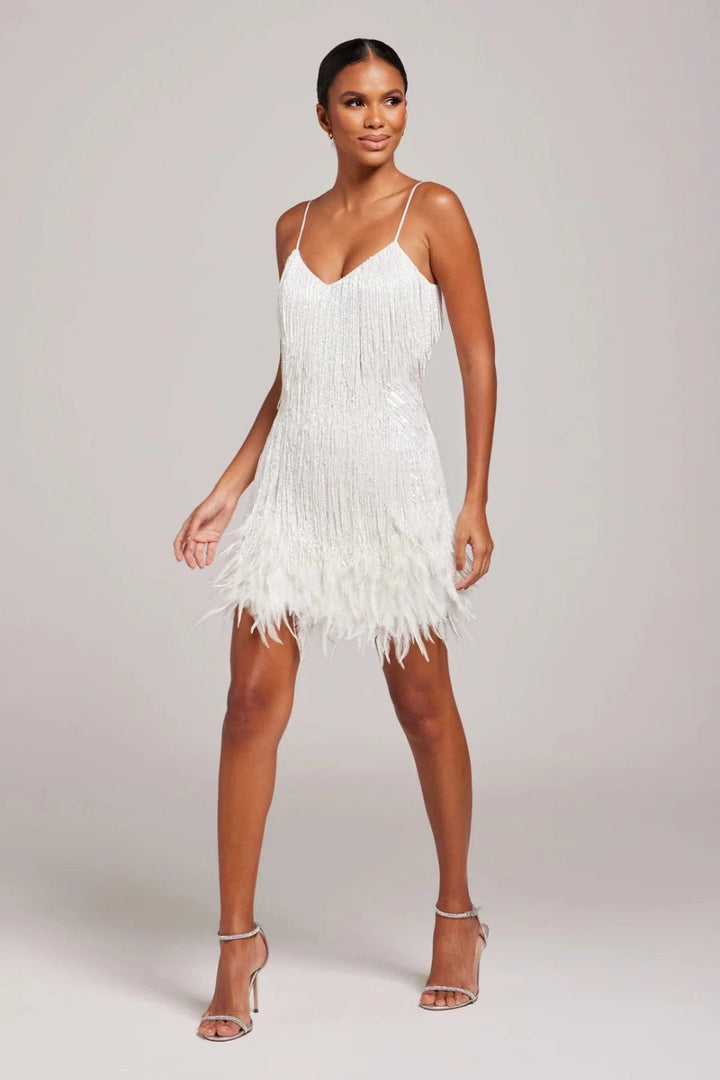 Fitted women's mini dress featuring delicate spaghetti straps, playful fringe, and chic feather trim.