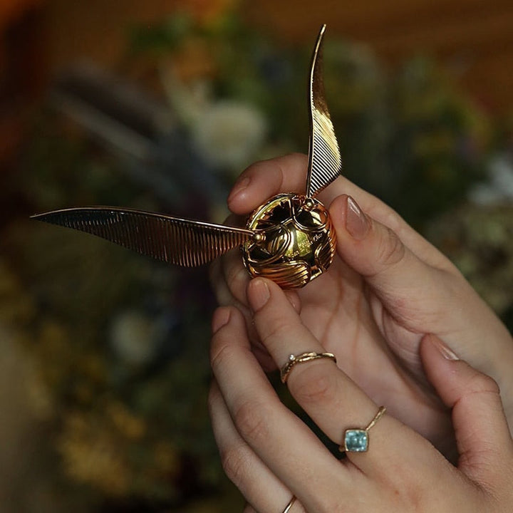 Fantasy-themed Golden Winged Orb jewelry box, stunning collectible display case for rings.