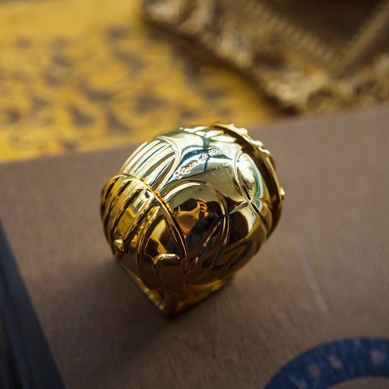 Elegant gold-plated Winged Orb ring display case, collectible fantasy decor gift.