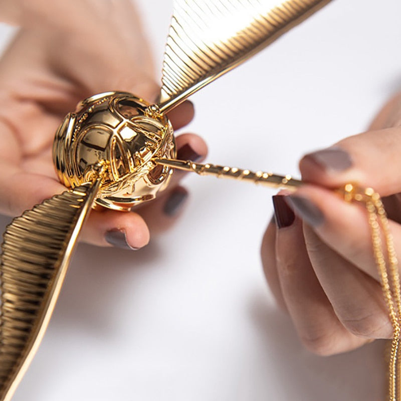 Collectible fantasy decor: Golden Winged Orb movable ring box, unique jewelry storage.