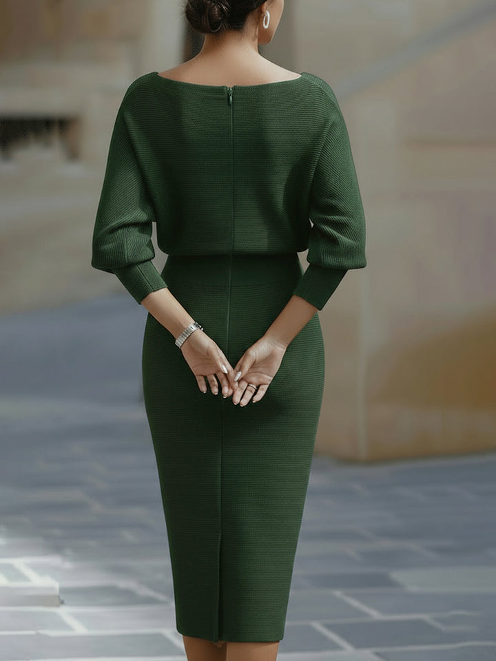 Close-up of elegant draping on a women's batwing midi dress, highlighting luxurious fabric.