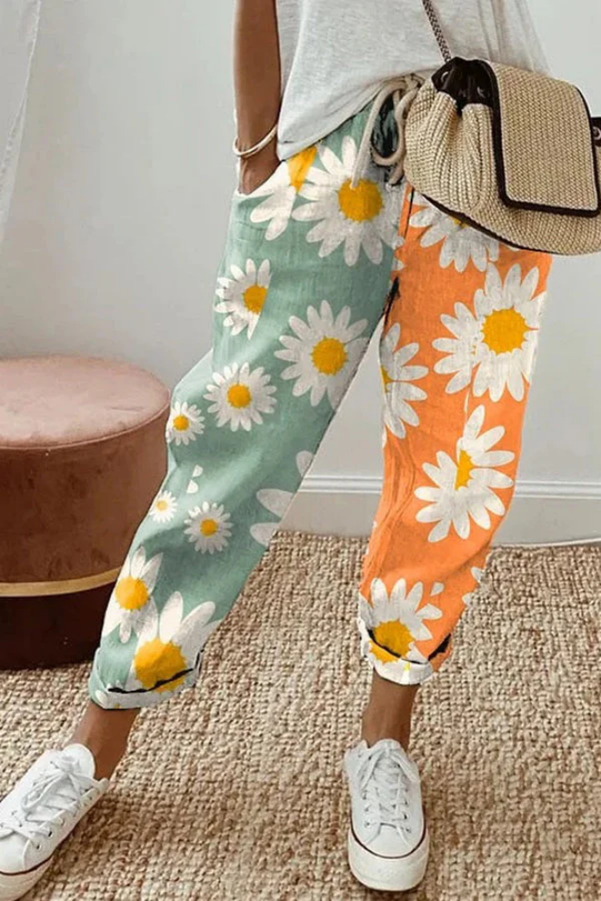 Front view of chic women's casual printed pants, showcasing button accents, pockets, and flowy silhouette.