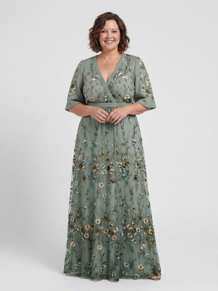 Women's green floral V-neck short sleeve maxi dress with elegant flowing design. Ideal for summer evenings.