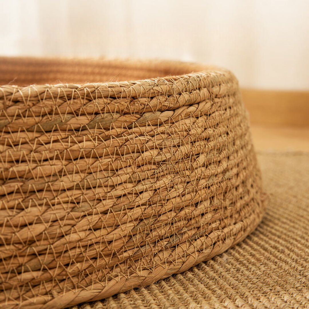 Stylish rattan cat bed and scratching post. Hand-woven, natural design for a comfortable pet home.