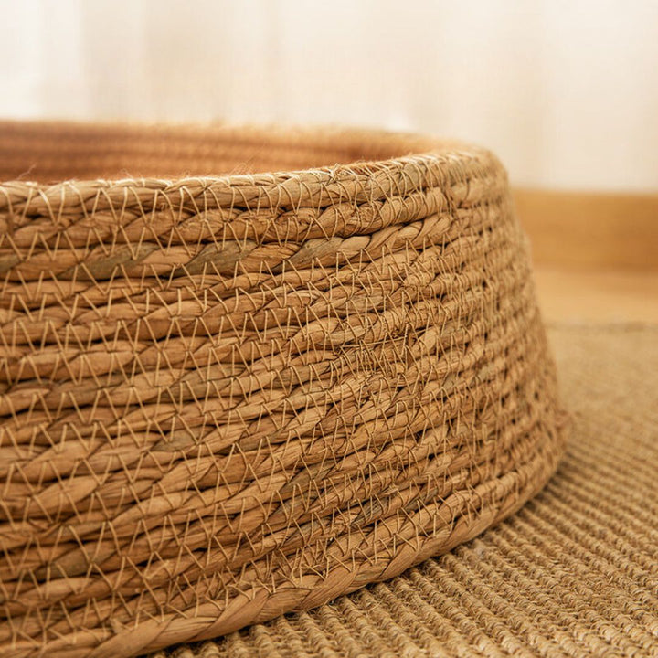Stylish rattan cat bed and scratching post. Hand-woven, natural design for a comfortable pet home.