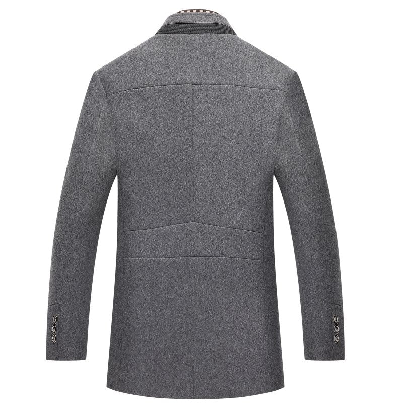 Man wearing a stylish mid-length overcoat with a mandarin collar. Elegant men's winter outerwear with buttons.