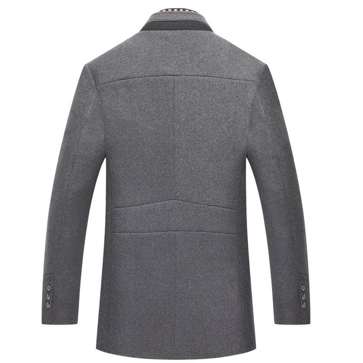 Man wearing a stylish mid-length overcoat with a mandarin collar. Elegant men's winter outerwear with buttons.