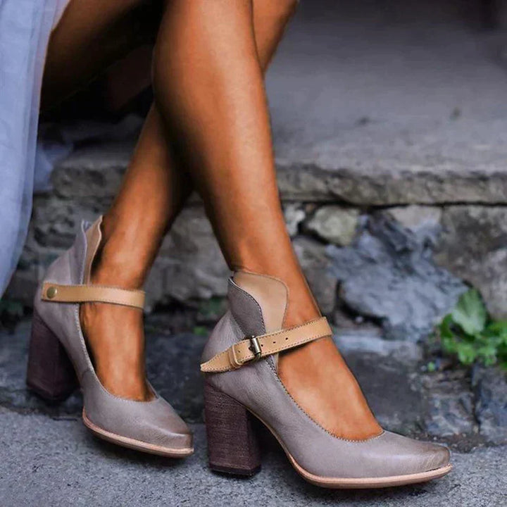 Fashionable women's closed toe block heel pumps with an ankle strap, offering comfort for all-day wear.