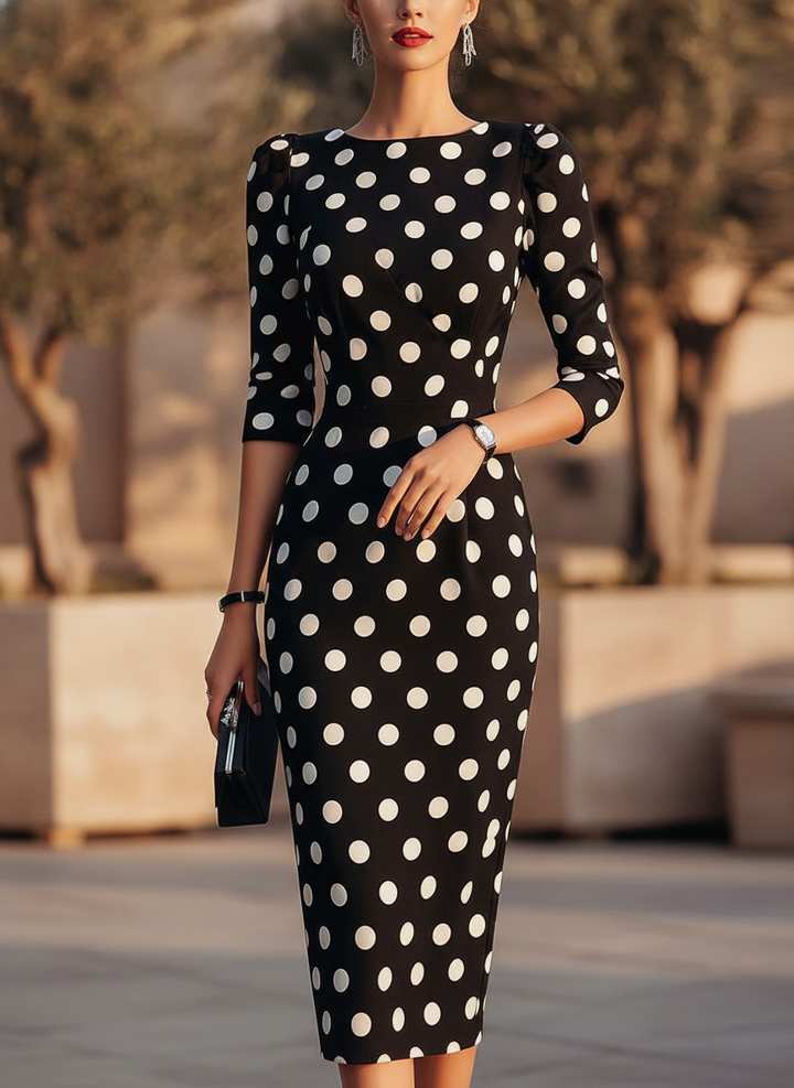 Women's black halter neck bodycon midi cocktail dress with white dot print, perfect for evening wear.