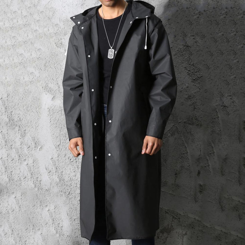 Stylish men's black waterproof long rain jacket for autumn & spring, offering ultimate all-weather outdoor protection.