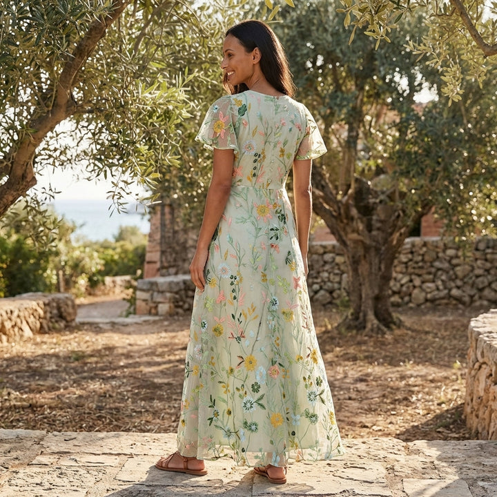 Flowy floral print maxi dress for women featuring a stylish V-neck and short sleeves. Ideal for casual or party wear.