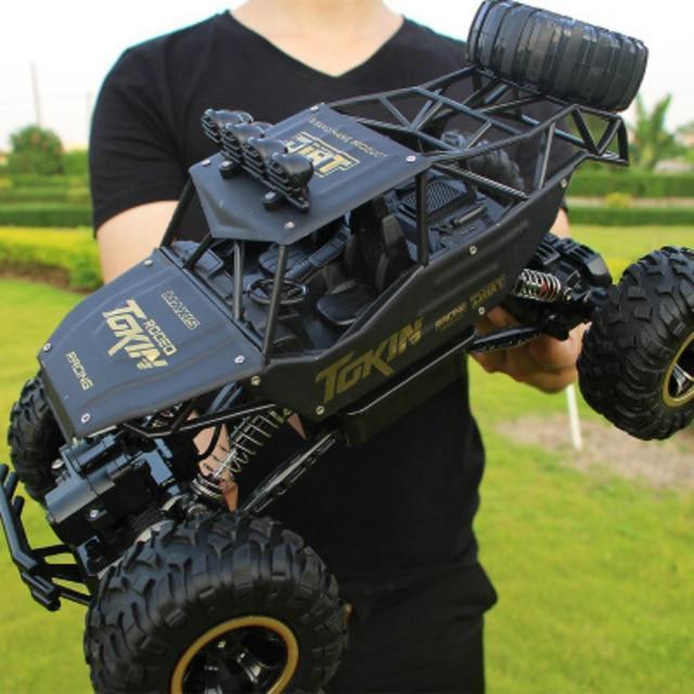 High-speed 4x4 RC monster truck conquering an off-road track, showcasing its durable build and all-terrain capabilities.