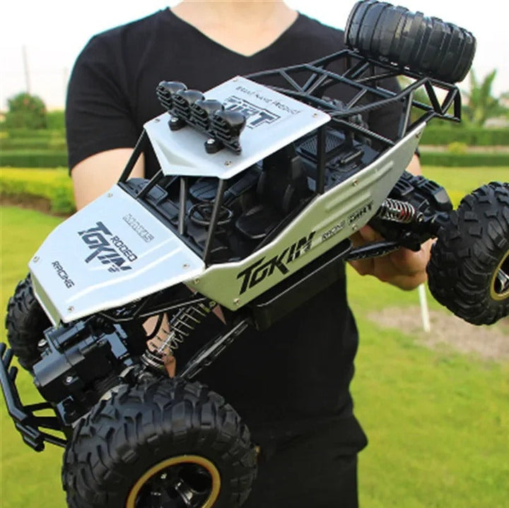 Close-up of a rugged 4x4 RC monster truck, highlighting its all-terrain tires and ready for high-speed off-road action.
