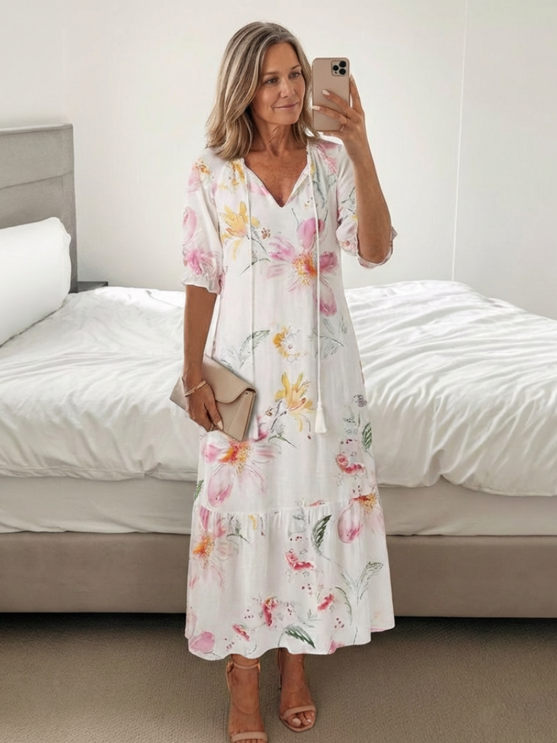 Vibrant floral print women's midi dress. Short sleeve, V-neck, and relaxed fit make it a perfect casual summer dress.