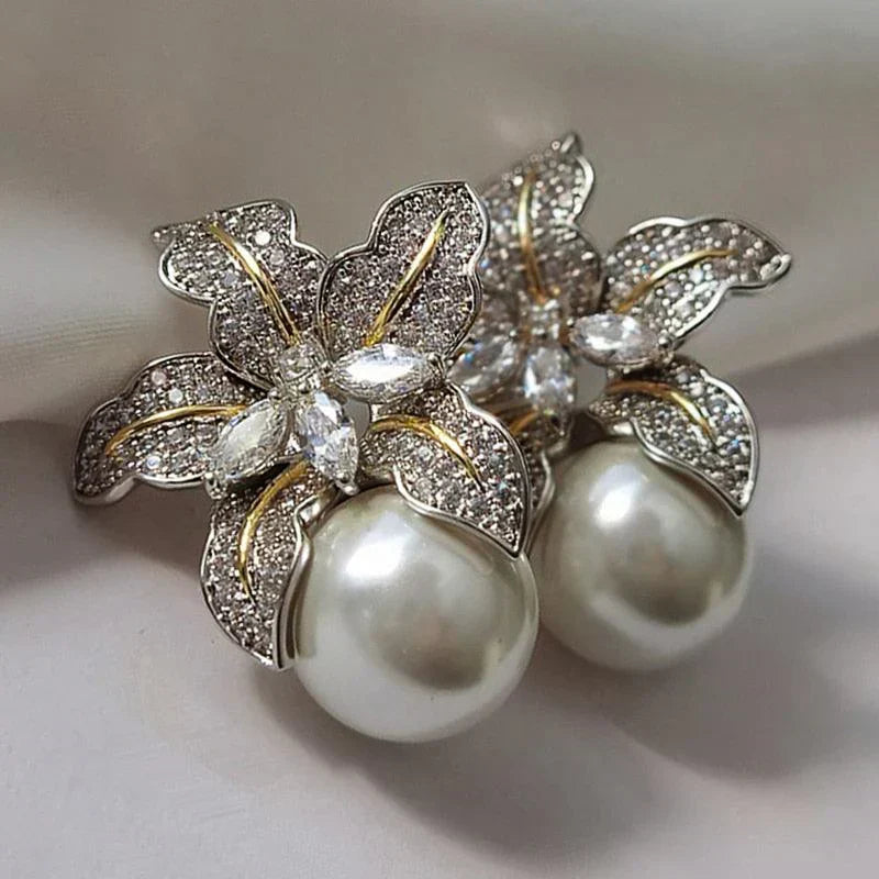 Exquisite women's flower pearl drop earrings. Elegant jewelry fashion accessory with delicate pearls.
