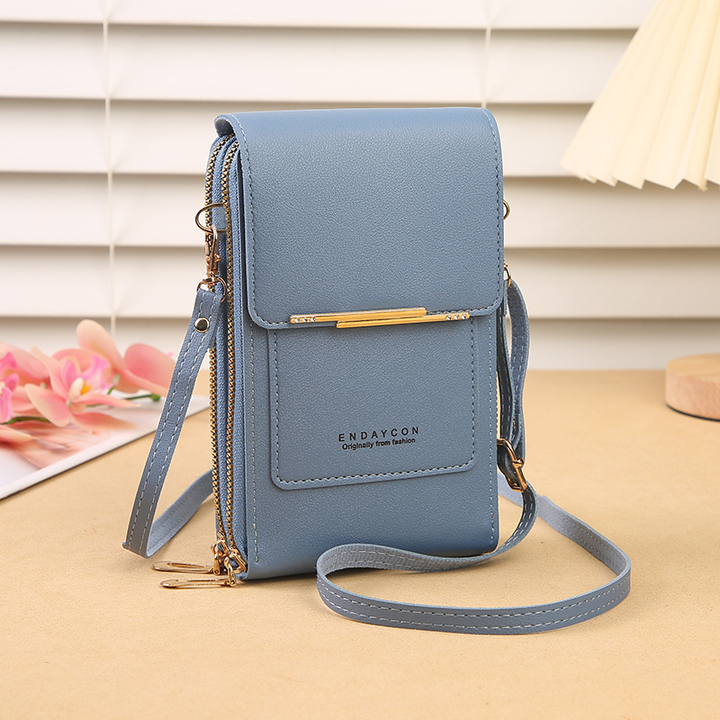 Close-up of a women's touchscreen crossbody bag, showcasing its wallet compartments and soft PU leather texture.