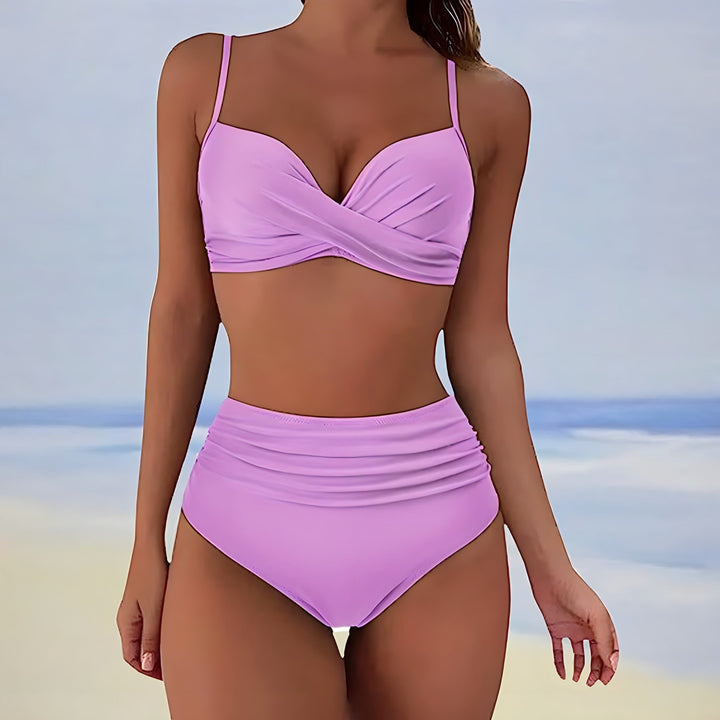 Two-piece women's swimwear: high waisted bikini with unique twist front design, flattering fit.