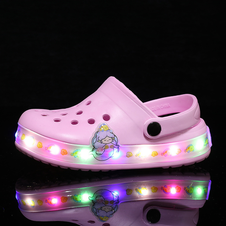 Children's glow-in-the-dark slip-on clogs, perfect beach shoes for water play & summer fun.