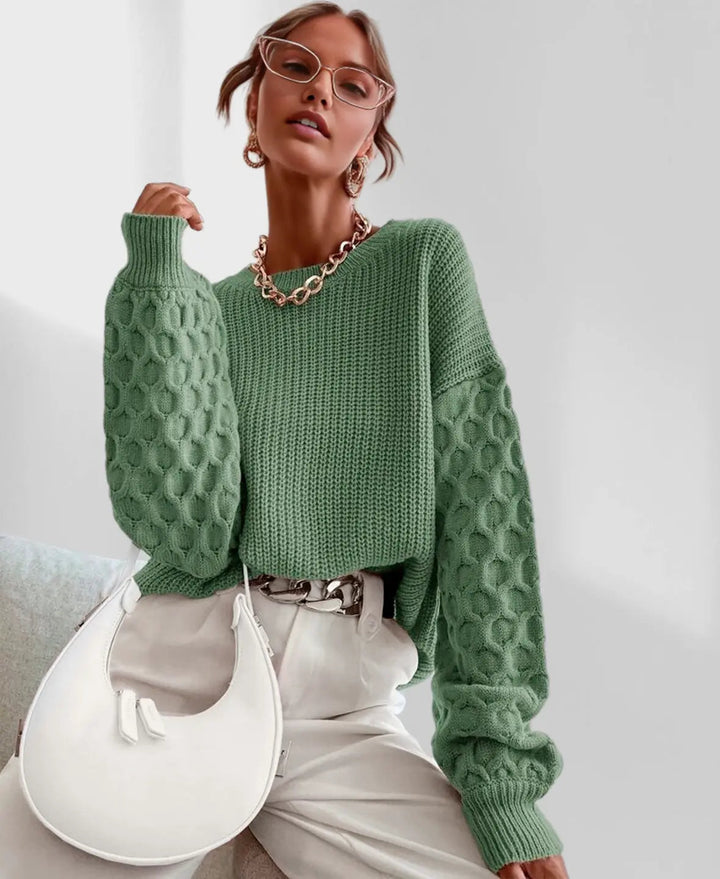 Detailed shot of the elegant lantern sleeve on the women's spring knit sweater. Stylish knitwear.