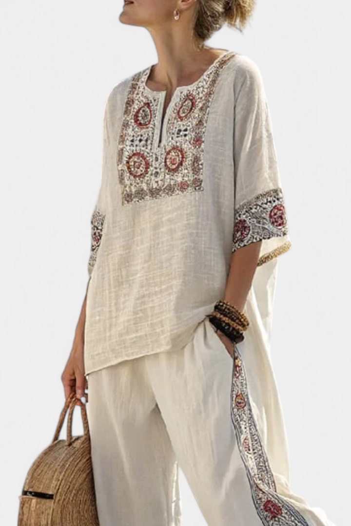 Sophisticated women's set: embroidered floral blouse with wide-leg trousers. Perfect for spring/summer casual elegance.