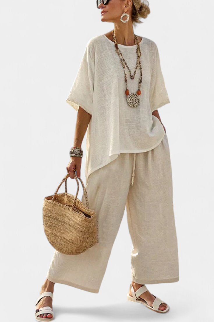 Women's comfortable minimalist white two-piece set with a casual blouse and wide-leg pants, perfect for summer lounge.