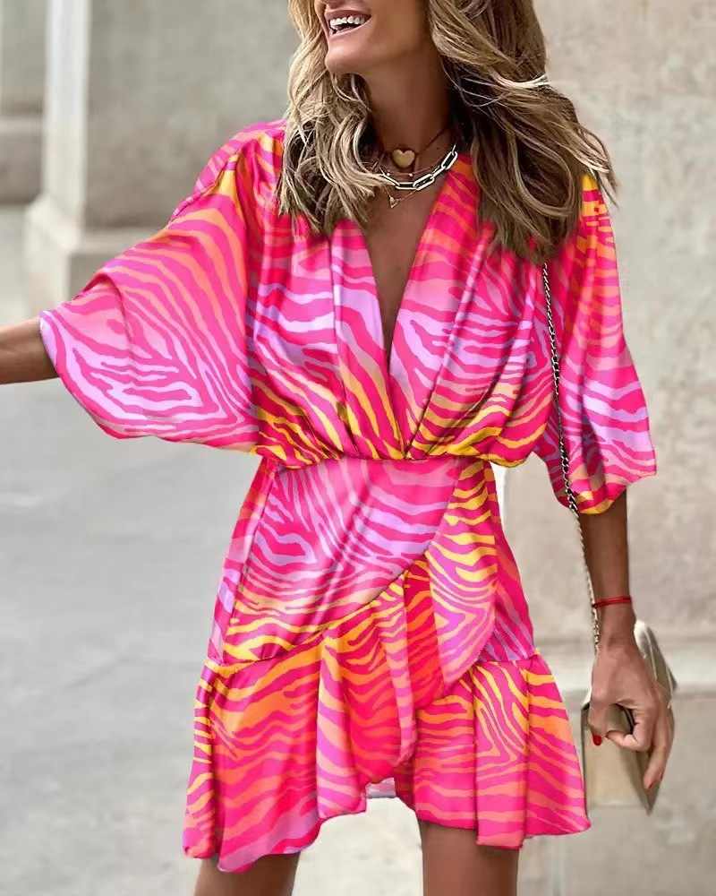 Short orange ruffled boho dress, a chic ladies' fashion piece with a bohemian summer style.