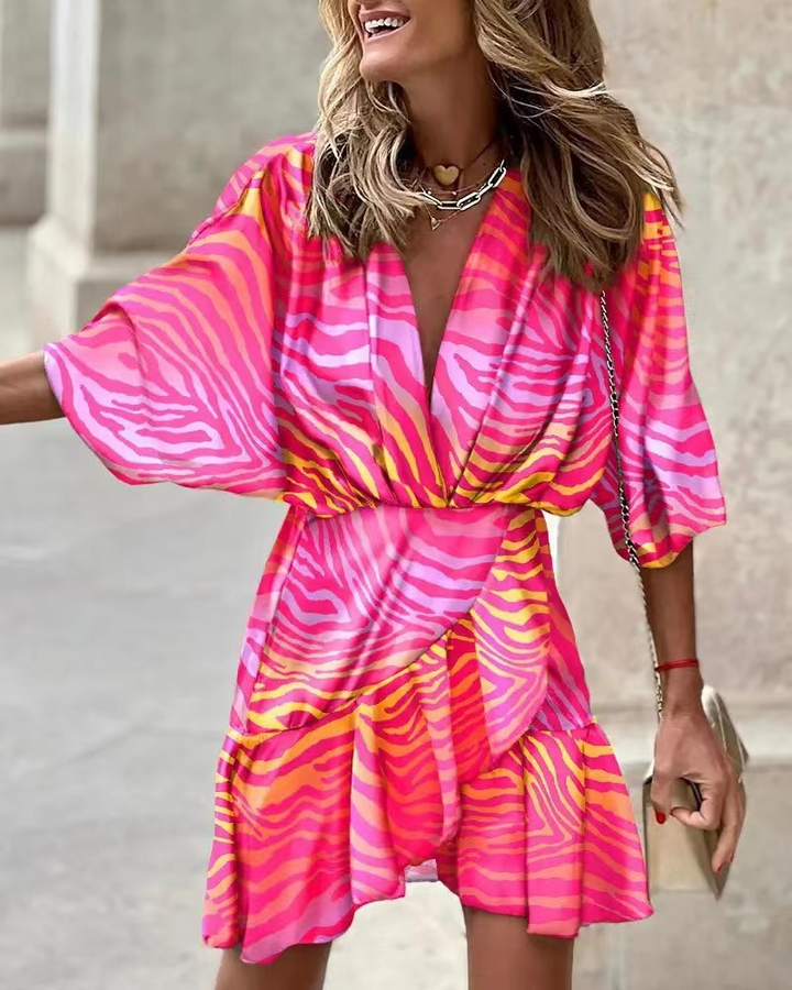 Short orange ruffled boho dress, a chic ladies' fashion piece with a bohemian summer style.