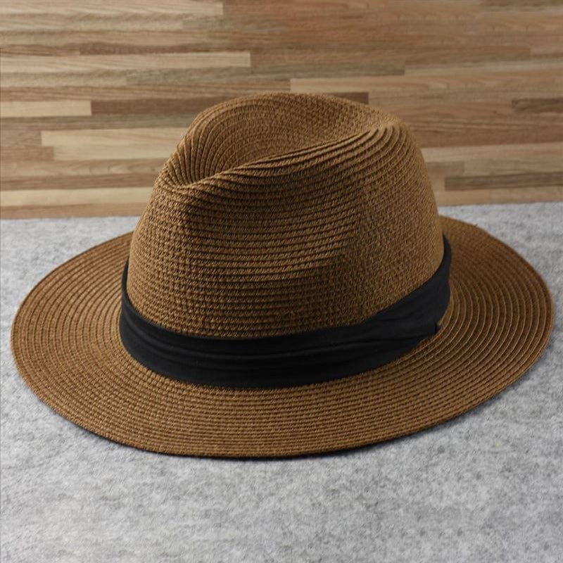 Person wearing a classic unisex Panama straw hat, offering ultimate sun protection and a relaxed summer style.