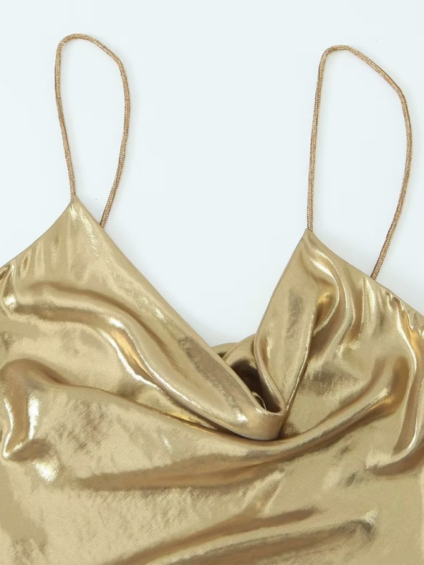 Trendy deep back dress with metallic shoulder straps, a chic choice for any party.