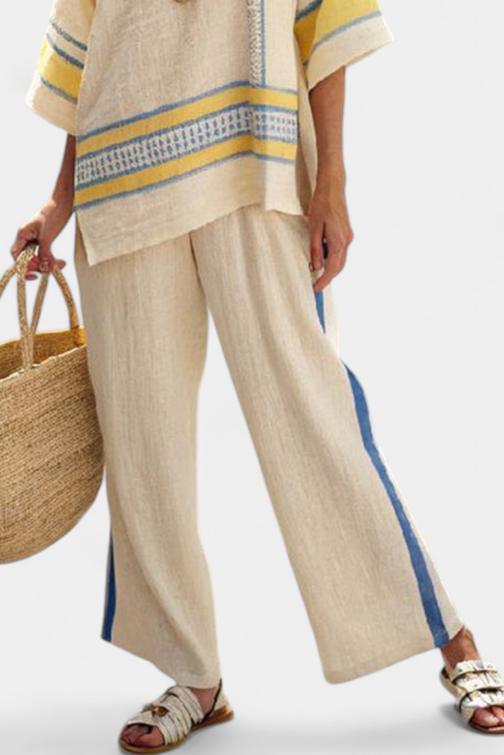 Stylish women's blue-yellow Mediterranean summer set. Comfortable, multi-colored flowy top & wide-leg pants outfit.